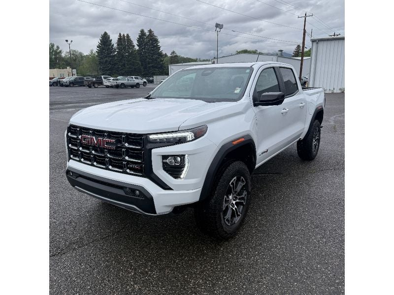 2024 GMC Canyon AT4 in Summit White — front three-quarter view